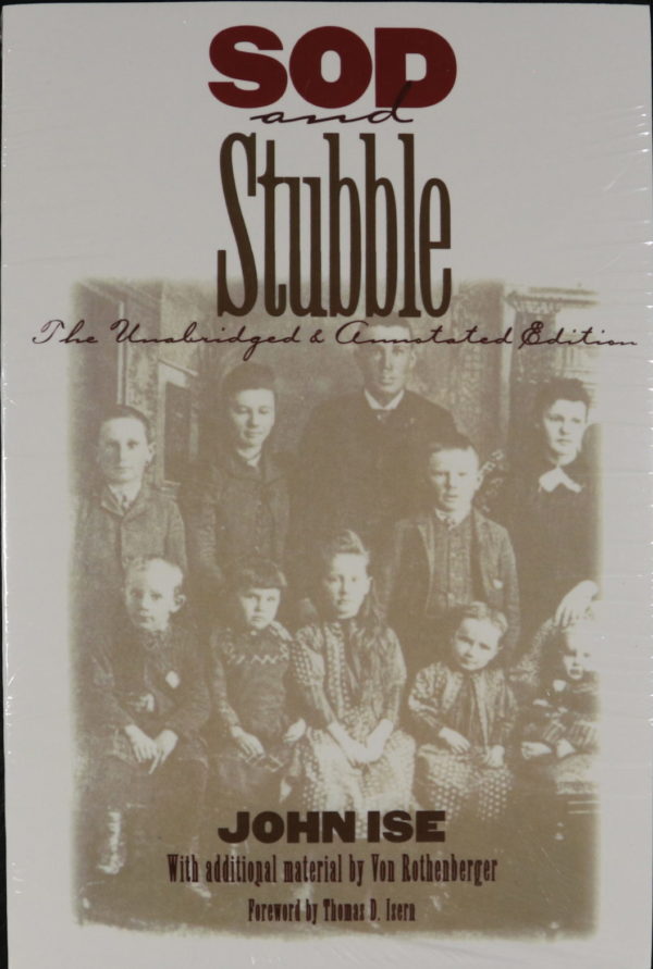 A faded image in sepia tones of a family photograph in old-fashioned dress. A man and woman are at the center in the back, with three children to their left and right. Sitting in a row in front of them are another five children of various ages. Text on the cover reads: "Sod and Stubble. The Unabridged and Annotated Edition. John Ise. With additional material by Von Rothenberger. Foreword by Thomas D. Isern.