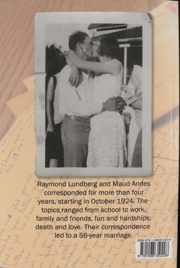 A slightly damaged black and white photo of a man and woman kissing. Her arms are around his neck and his hands rest, folded, at the small of her back. In the background behind the photo is an image of handwritten letters.