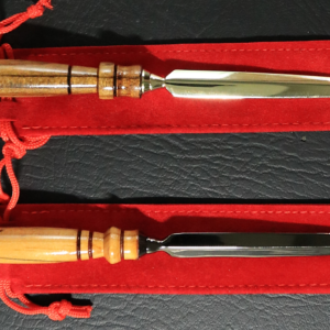 Two metal-bladed letter openers with dark-banded wooden handles. One has gold-tone metal accents and the other has black-toned metal.