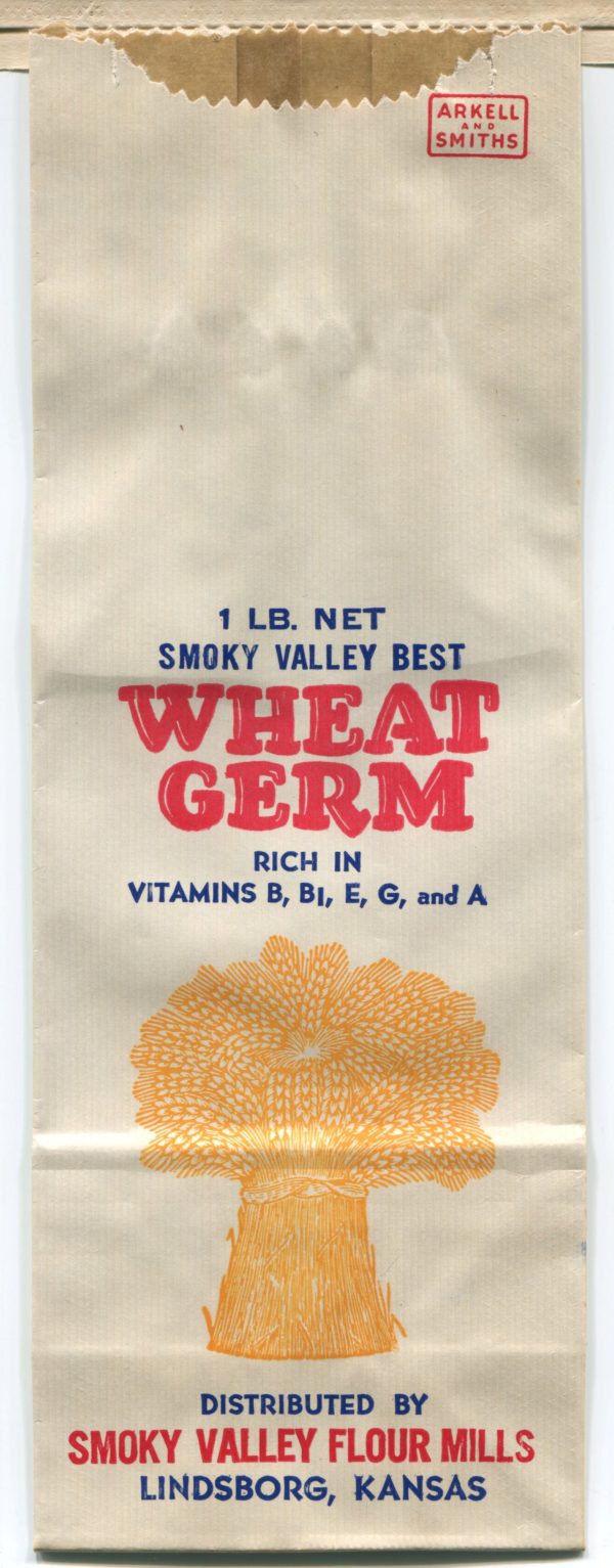 A flat, unused paper flour bag. In the center of the image is a bundle of yellow wheat. Text reads: "1 pound net. Smoky Valley Best Wheat Germ. Rich in Vitamins B, B7, E, G, and A. Distributed by Smoky Valley Roller Mills. Lindsborg, Kansas."